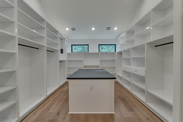 walk in closet featuring light hardwood / wood-style flooring