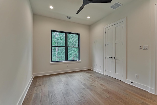 empty room with light wood-type flooring and ceiling fan