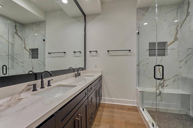 bathroom with vanity, hardwood / wood-style flooring, and walk in shower