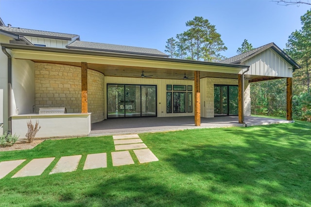 back of house featuring ceiling fan, a yard, and a patio