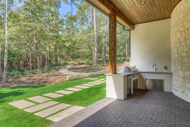 view of patio featuring area for grilling, sink, and an outdoor kitchen