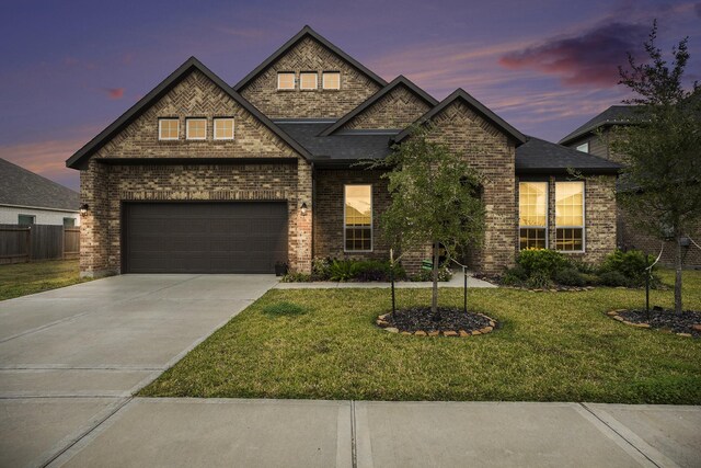 view of front of house featuring a lawn and a garage