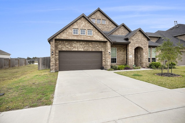 view of front of house featuring a front yard and a garage