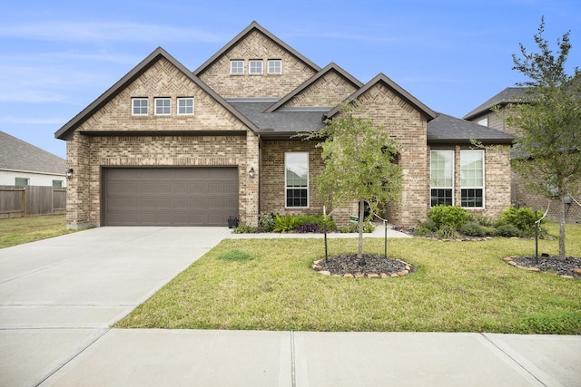 view of front of house with a garage and a front lawn