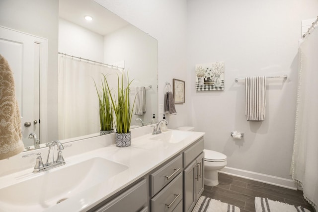 bathroom with vanity, hardwood / wood-style flooring, and toilet