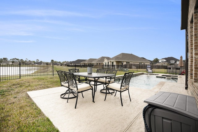 view of patio with a water view and a fenced in pool