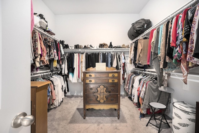 walk in closet featuring light carpet