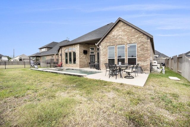 rear view of property featuring a patio and a lawn