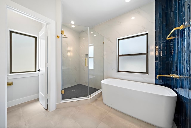 bathroom featuring plus walk in shower and tile walls