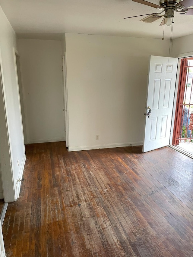 unfurnished room featuring dark hardwood / wood-style floors and ceiling fan