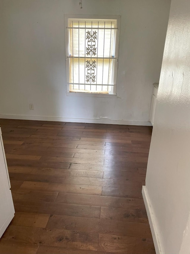 unfurnished dining area with dark wood-type flooring