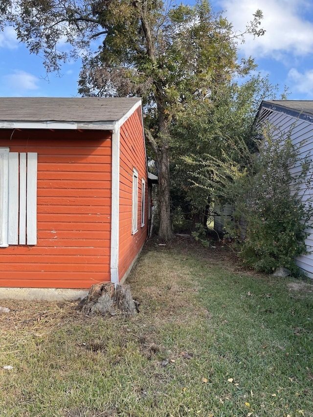 view of side of home featuring a yard