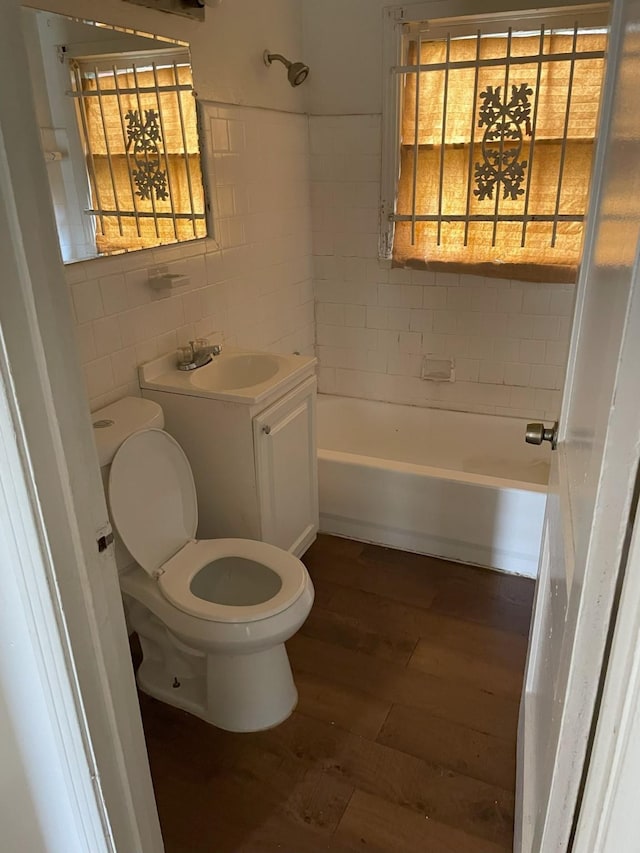 full bathroom featuring backsplash, vanity, tile walls, hardwood / wood-style floors, and toilet