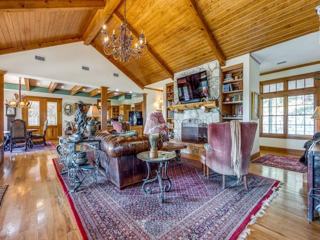 living room featuring light wood-type flooring, a stone fireplace, plenty of natural light, and wood ceiling