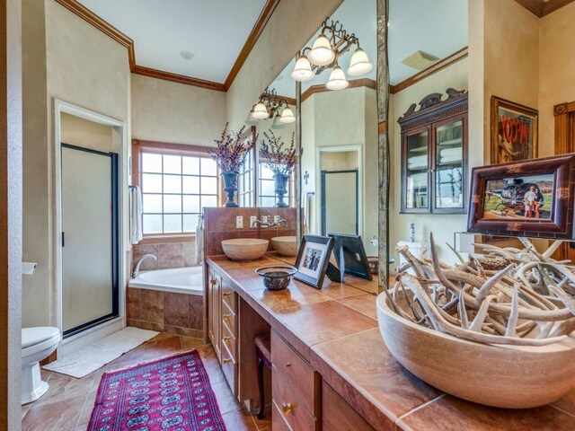 full bathroom featuring vanity, crown molding, an inviting chandelier, independent shower and bath, and tile patterned flooring