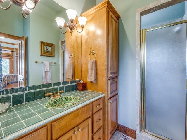 bathroom with a chandelier, vanity, and an enclosed shower