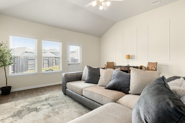 living room featuring light hardwood / wood-style flooring, vaulted ceiling, and ceiling fan