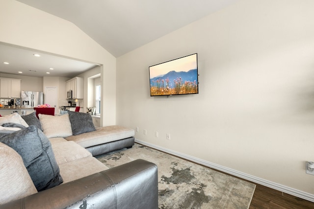 living room featuring light hardwood / wood-style flooring and vaulted ceiling