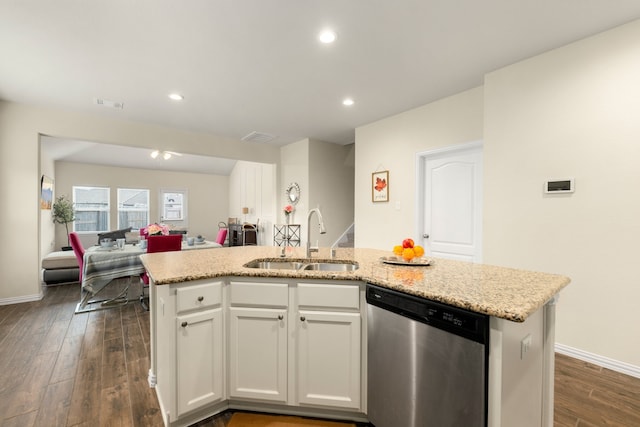 kitchen with dishwasher, white cabinets, an island with sink, and sink