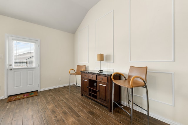 home office with dark hardwood / wood-style flooring and lofted ceiling