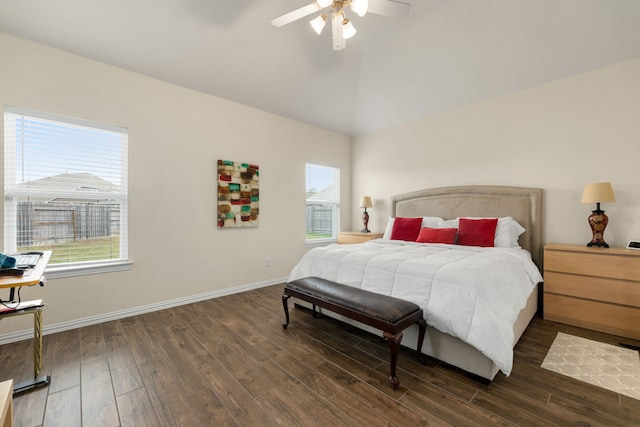 bedroom with ceiling fan, dark wood-type flooring, and lofted ceiling