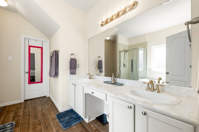 bathroom with hardwood / wood-style floors, vanity, and walk in shower