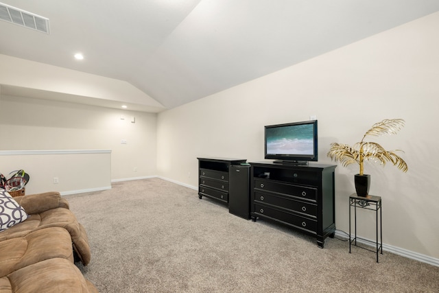 living room featuring light colored carpet and vaulted ceiling