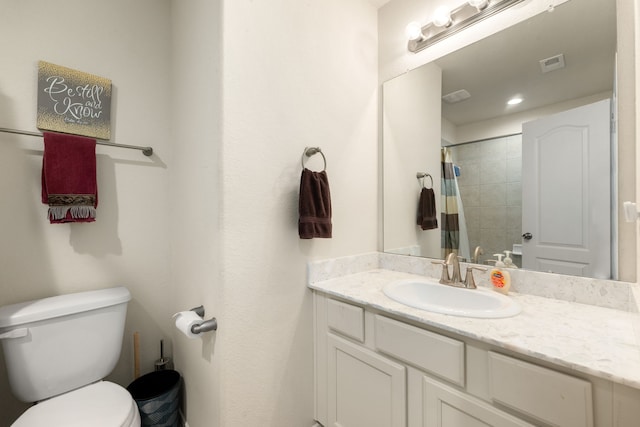 bathroom with a shower with shower curtain, vanity, and toilet