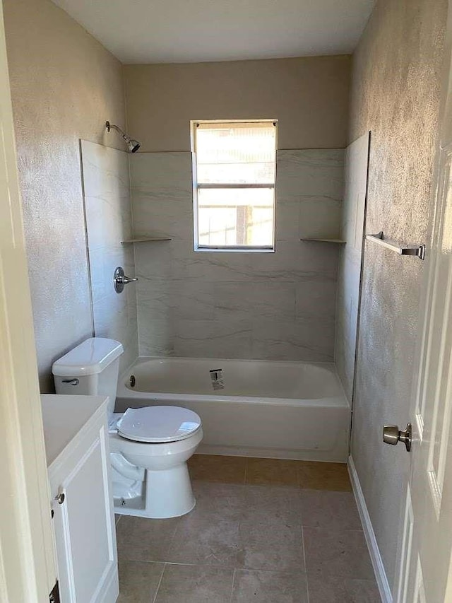 full bathroom featuring tile patterned flooring, toilet, vanity, and tiled shower / bath