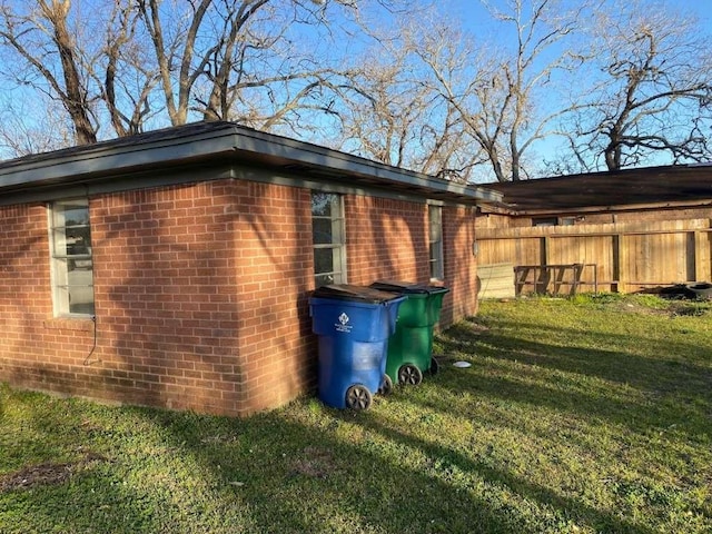 view of side of property with a lawn