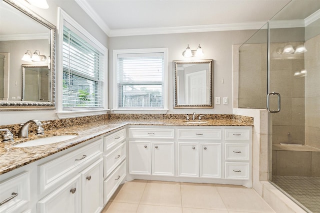 bathroom featuring vanity, tile patterned floors, a shower with shower door, and crown molding