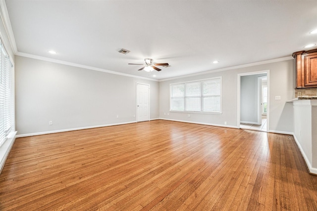 unfurnished living room featuring ceiling fan, ornamental molding, and light wood-type flooring