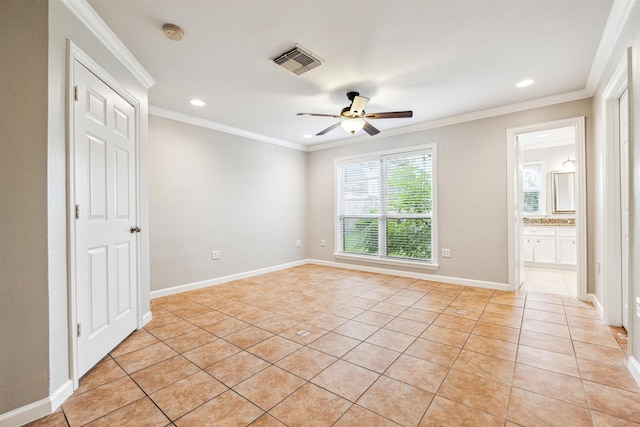 empty room with ceiling fan, light tile patterned flooring, and ornamental molding