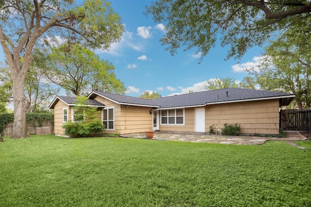 rear view of property with a yard