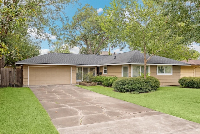 single story home featuring a front yard and a garage