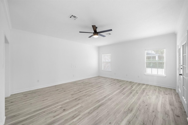 empty room featuring ceiling fan, light hardwood / wood-style floors, and ornamental molding