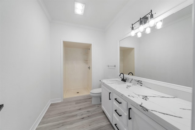 bathroom featuring a shower, hardwood / wood-style floors, crown molding, toilet, and vanity