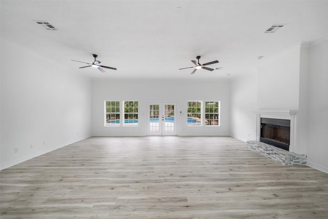 unfurnished living room with french doors, light hardwood / wood-style flooring, ceiling fan, and crown molding