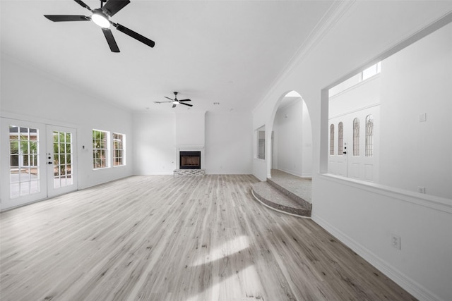 unfurnished living room featuring french doors, light hardwood / wood-style floors, ceiling fan, and crown molding