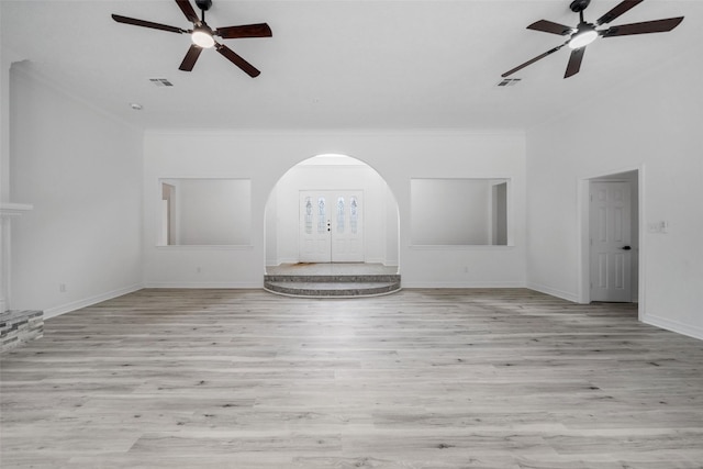 unfurnished living room with ceiling fan, light hardwood / wood-style floors, and ornamental molding