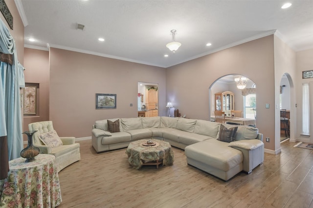 living room with crown molding and light hardwood / wood-style flooring