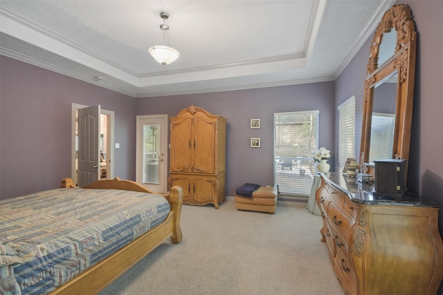 carpeted bedroom with ornamental molding, a textured ceiling, and a tray ceiling