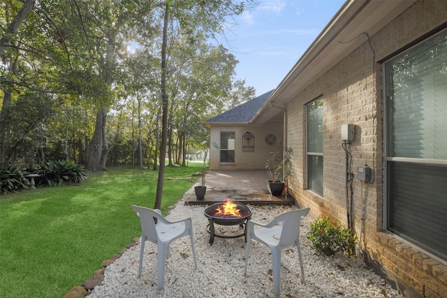 view of yard featuring a patio and a fire pit