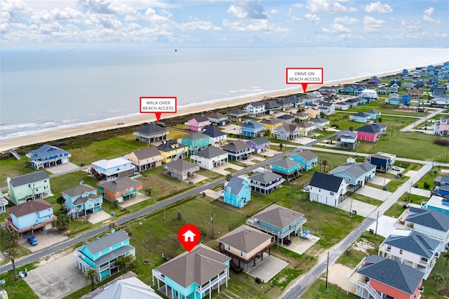 aerial view featuring a water view and a beach view