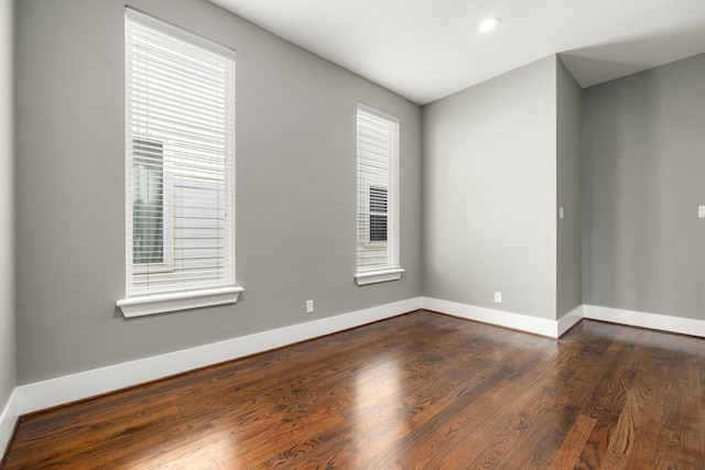 unfurnished room featuring dark hardwood / wood-style flooring