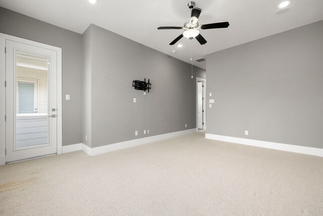 empty room with ceiling fan and carpet floors