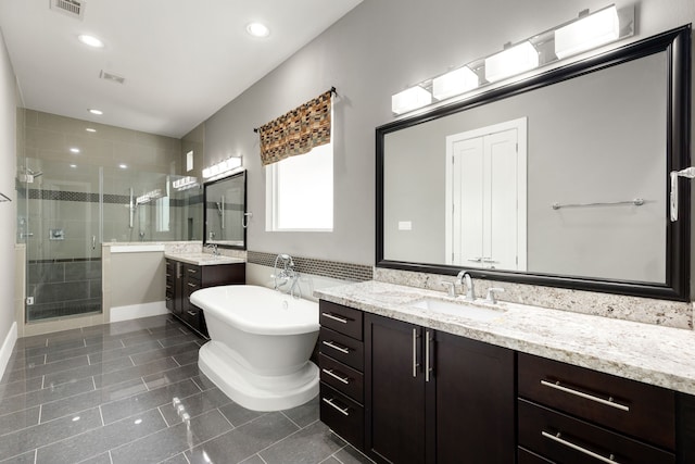 bathroom featuring shower with separate bathtub and vanity