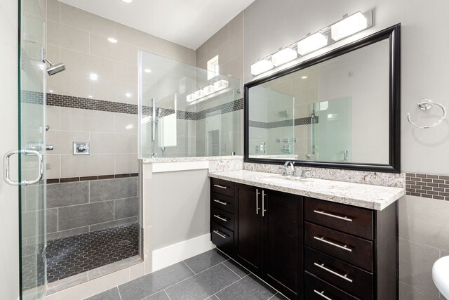 bathroom with vanity, tile patterned floors, and a shower with shower door