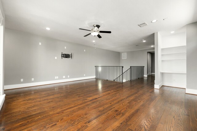 spare room featuring ceiling fan and dark wood-type flooring