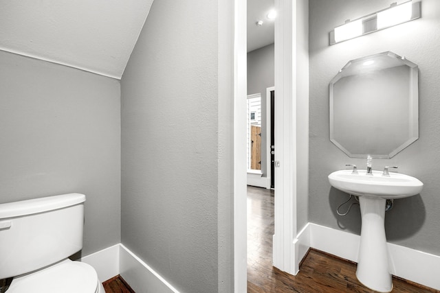 bathroom with sink, hardwood / wood-style floors, and toilet